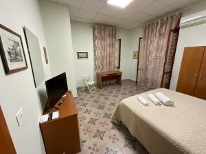 a hotel room with a bed and a television at In pieno centro in Crotone