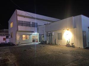 a building with a light on the side of it at night at HOTEL Saboten Apartment in Miyoshi