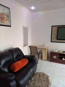 a living room with a leather couch and a table at Yadah Accommodations in Lothlekane