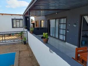 a house with a balcony with a swimming pool at Yadah Accommodations in Lothlekane