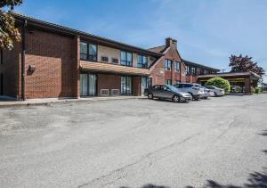 a parking lot in front of a brick building at Comfort Inn Sherbrooke - Estrie in Sherbrooke