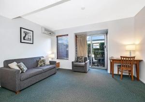 a living room with a couch and a table at Comfort Inn & Apartments Northgate Airport in Brisbane