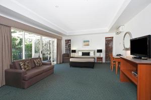 a living room with a couch and a bedroom at Comfort Inn & Apartments Northgate Airport in Brisbane