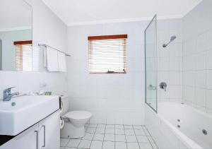 a white bathroom with a sink and a toilet at Comfort Inn & Apartments Northgate Airport in Brisbane +45 photos