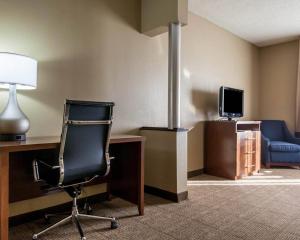 a room with a desk and a chair and a tv at Comfort Suites Tulsa Central in Tulsa