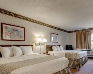 a hotel room with two beds and a window at Econo Lodge Inn & Suites El Paso West in El Paso