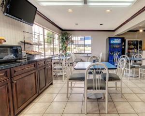 a kitchen and dining room with a table and chairs at Econo Lodge Inn & Suites El Paso West in El Paso