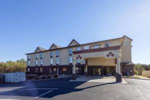 a large building with a parking lot in front of it at Clarion Pointe I-85 High Point - Archdale in Westwood