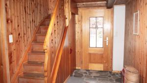 a wooden staircase in a room with a door at Rustico Pagrüeg - Swiss Alpine Charm 1-5 Pers in Klosters Serneus