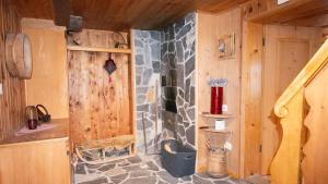 a bathroom with a stone shower in a cabin at Rustico Pagrüeg - Swiss Alpine Charm 1-5 Pers in Klosters Serneus
