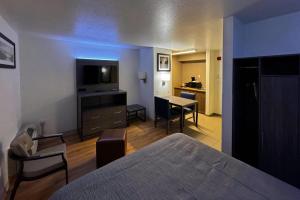 a hotel room with a bed and a dining room at Quality Inn Fishers - Indianapolis in Fishers