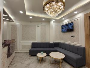 a living room with a couch and two tables at Baba Palace in Ayodhya