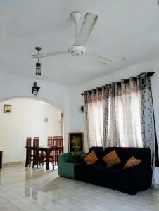 a living room with a couch and a table at Oshi villa in Hikkaduwa