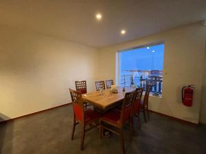 a dining room with a table and chairs and a window at Laplanders room 14 in Kiruna