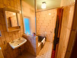 a small bathroom with a sink and a mirror at HOTEL Saboten Apartment in Miyoshi +11 photos