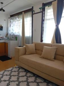 a living room with a couch and a kitchen at Belaire BnB Ruaka 1 in Nairobi