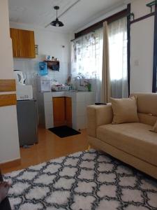 a living room with a couch and a kitchen at Belaire BnB Ruaka 1 in Nairobi