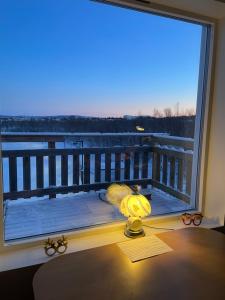 a desk with a window view of a balcony at Laplanders room 14 in Kiruna
