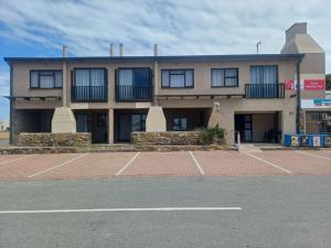 a building with a parking lot in front of it at Gouritsmond Self Catering Units in Gouritzmond
