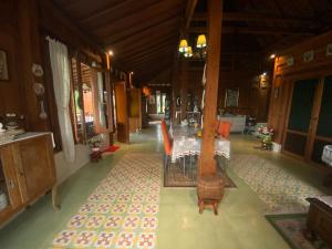 a dining room with a table and chairs at Sembung Healing House in Sangeh