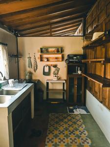 a kitchen with a sink and a counter with a rug at Sembung Healing House in Sangeh