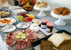 a table topped with lots of different types of food at De Wingerd Wijnland Lodge in Paarl