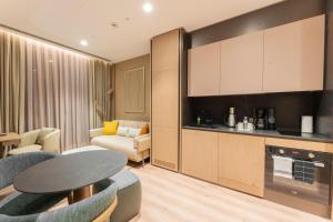 a kitchen and living room with a table and chairs at Marriott Executive Apartments Antalya in Antalya