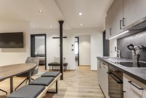 a kitchen with a table and a dining room at ötztalLOFT in Längenfeld
