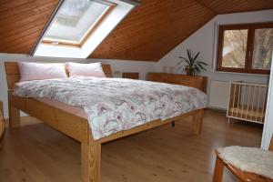 a bedroom with a bed in a attic at FeWo Wacholderheide in Langenau
