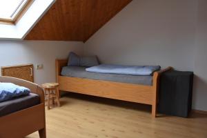 a bedroom with two beds in a attic at FeWo Wacholderheide in Langenau
