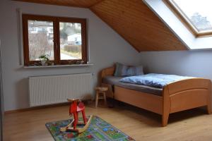 a small bedroom with a bed and a window at FeWo Wacholderheide in Langenau