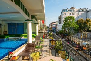 a view from the balcony of a building with a swimming pool at Thanh Lich Hue Hotel in Hue
