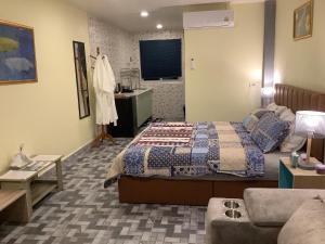 a bedroom with a bed and a couch at CC Homestay in Surin