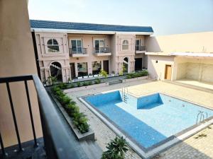 an aerial view of a house with a swimming pool at R N Hotel & Lawn in Katra +19 photos