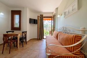 a living room with a couch and a table at Pargadise Aprtments in Parga