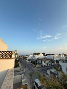 a view of a parking lot from a balcony at Bilocale zona spiaggia Home Salento com in Torre San Giovanni Ugento +13 photos