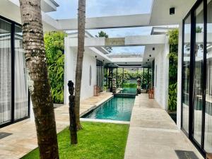 an indoor pool in the middle of a house at Villa Australis in Kerobokan