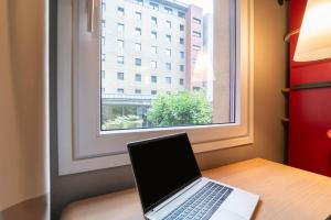 a laptop sitting on a table in front of a window at ibis Amsterdam Centre Stopera in Amsterdam
