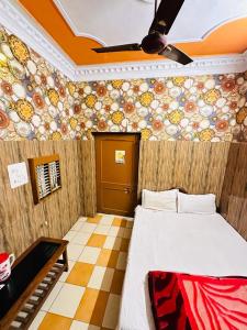 a room with a bed and a ceiling fan at Hotel New Lucknow in Lucknow
