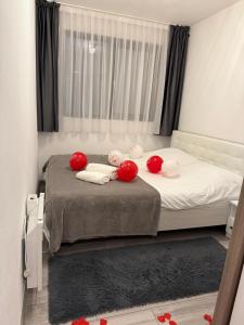 a small bedroom with a bed with red pillows at Tiny House by the forest 1 in Borod +9 photos