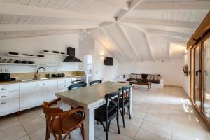 a kitchen and dining room with a table and chairs at Pargadise Aprtments in Parga