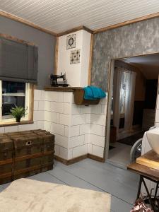 a living room with a kitchen and an open door at Villa Björksele in Björksele +35 photos