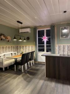 a dining room with a table and chairs and a window at Villa Björksele in Björksele