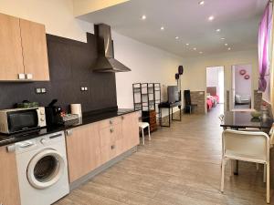 a kitchen with a washer and dryer in a room at Apartaments IRI in Pineda de Mar