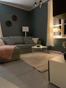 a living room with a couch and a table at Villa Björksele in Björksele