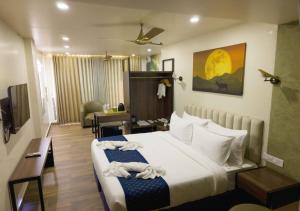 a bedroom with a large bed and a living room at River Bay Athirappilly in Athirappilly