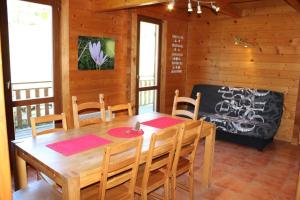 a dining room with a wooden table and chairs at Les castors in Roubion