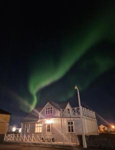 a house with the aurora in the sky at Pálshús in Patreksfjörður +11 photos