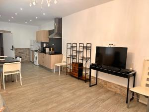 a living room with a flat screen tv and a table at Apartaments IRI in Pineda de Mar +22 photos