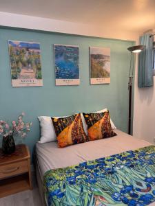a bedroom with a bed and posters on the wall at Maison d Eloise in Sartrouville +16 photos